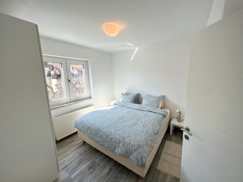 a bedroom with a bed and a window at Apartmani Jarun in Zagreb