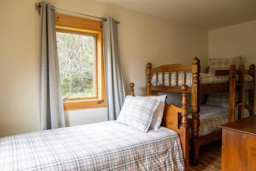 a bedroom with two bunk beds and a window at Cozy Cabin in Stratton Mountain & Mount Snow 10min in Stratton