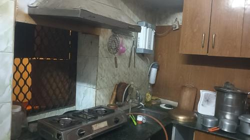 a kitchen with a stove and a counter top at DS Home in Lucknow