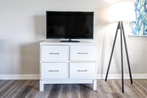 a white dresser with a flat screen tv on it at Perry's Ocean-Edge Resort in Daytona Beach