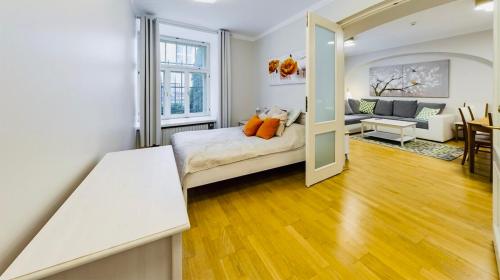 a bedroom with a bed and a living room at TallinnHousing Old Town Homes - 3 BDR Apartment in Rüütli in Tallinn