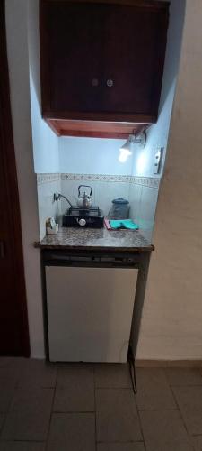 a kitchen counter with a stove on top of it at Palmeras Apart Hotel in Chascomús