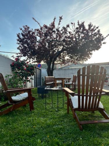 a patio with chairs and a table and a tree at EDEN GARDEN b&b in Ponferrada