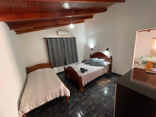 a bedroom with two beds in a room at ALOJAMIENTOS EN CATARATAS Depto 1 in Puerto Iguazú