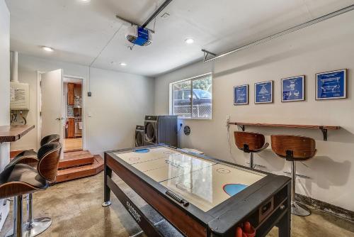 a ping pong table in a room with chairs at Bella Vita in Monte Rio