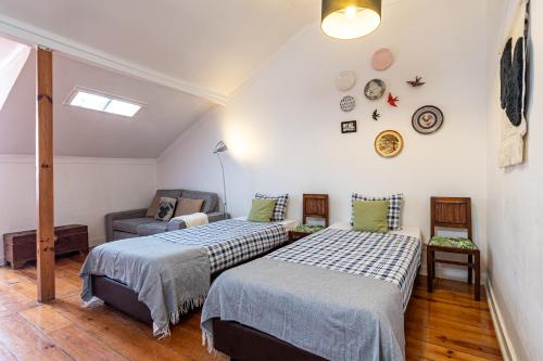 a room with two beds and a couch in it at Third floor apartment at Graça neighbourhood in Lisbon