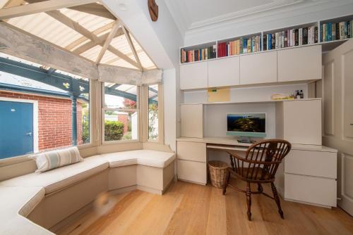 a room with a desk and a chair and a window at Sandringham Royale in Sandringham