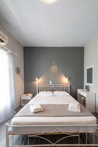 a bedroom with a large bed and a chandelier at Galini me thea in Chrissi Akti