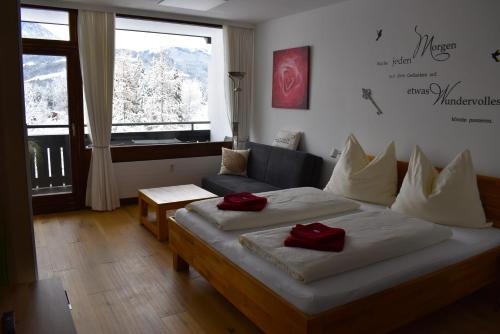 a bedroom with a bed with two red pillows on it at Apartment d´Auszeit in Bad Goisern