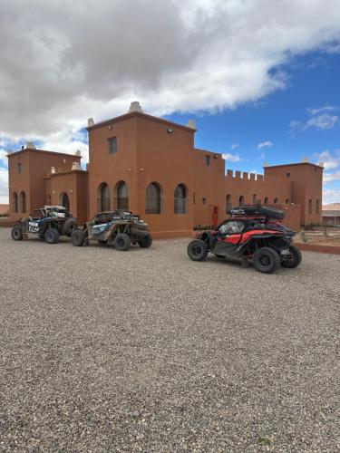 three atvs parked in front of a building at DAR AL QANASS IMANE in Midelt