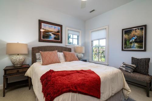 a bedroom with a large bed and two windows at 2271 Seabrook Island Road in Seabrook Island