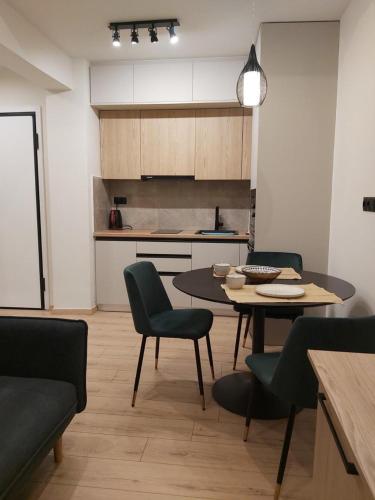 a kitchen with a table and chairs in a room at Real City Karagiorgi in Athens