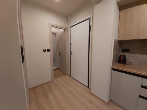 an empty room with a door and a kitchen at Real City Karagiorgi in Athens