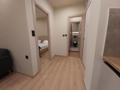 a hallway with a room with a bed and a mirror at Real City Karagiorgi in Athens