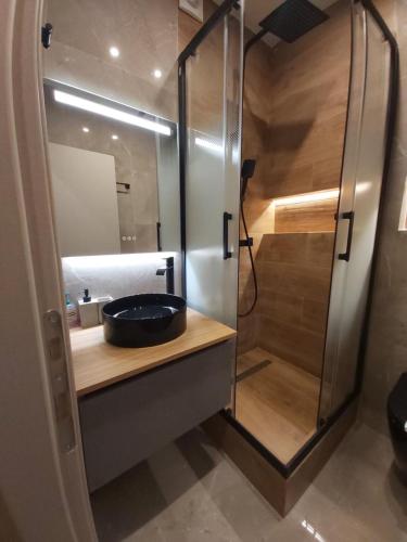 a bathroom with a sink and a shower at Real City Karagiorgi in Athens