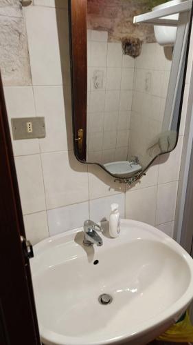 a bathroom with a sink and a mirror at La magia del trullo in Martina Franca