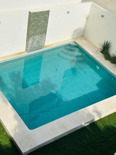 a large blue swimming pool in a yard at Casa Victoria Puerto Escondido Beach in Brisas de Zicatela