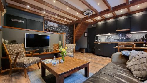 a living room with a couch and a table at Bed Op Steeg Vakantiehuis / Bed and Breakfast in De Steeg