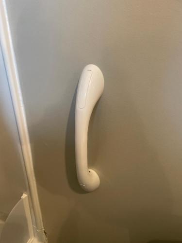 a white phone hanging on a wall at Dartt's Park Flat in Owatonna