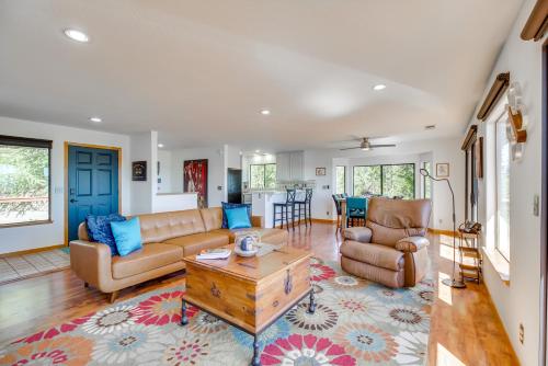 a living room with a couch and a coffee table at Idyllic Kelseyville Home with 2 Decks and Views! in Kelseyville