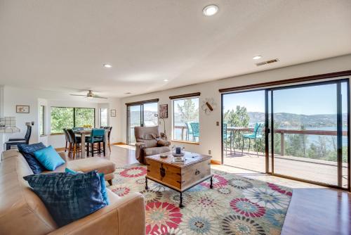 a living room with a couch and a table at Idyllic Kelseyville Home with 2 Decks and Views! in Kelseyville