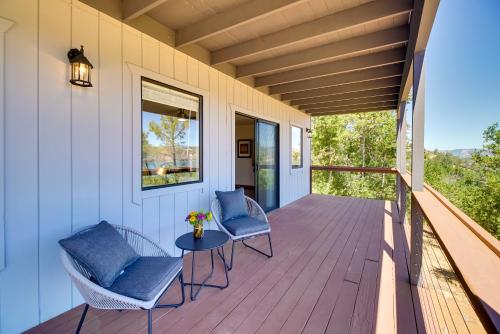 a porch with two chairs and a table on it at Idyllic Kelseyville Home with 2 Decks and Views! in Kelseyville