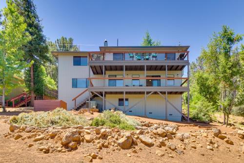 a building in the middle of a field with trees at Idyllic Kelseyville Home with 2 Decks and Views! in Kelseyville