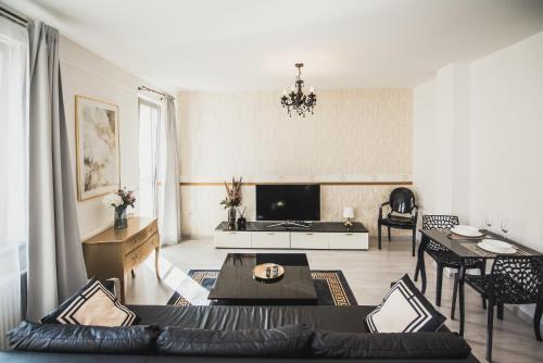 a living room with a couch and a table at ZARA LUXURY APARTMENTS The absolute center of Žilina in Žilina
