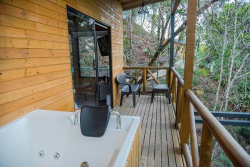a screened in porch with a sink and chairs on a deck at Eco Hotel The View in El Peñol