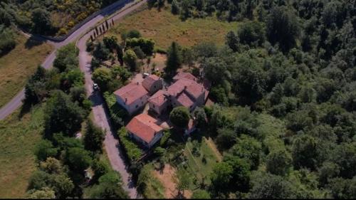 an aerial view of a house in the forest at Borgo Petraio in Montieri