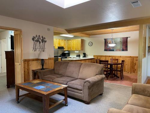 a living room with a couch and a table at Mount Shasta Resort in Mount Shasta