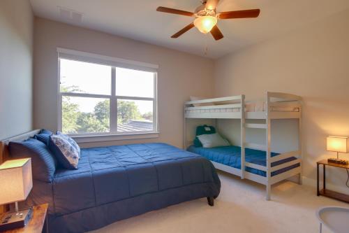 a bedroom with a bunk bed and a ceiling fan at Modern Lago Vista Home with Pool and Lake Access! in Lago Vista