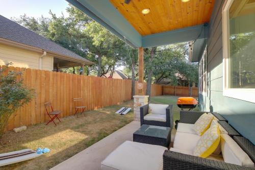 a patio with a couch and chairs and a fence at Modern Lago Vista Home with Pool and Lake Access! in Lago Vista