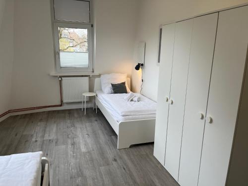 a small bedroom with a bed and a window at Schlafkonzept Hannover in Hannover