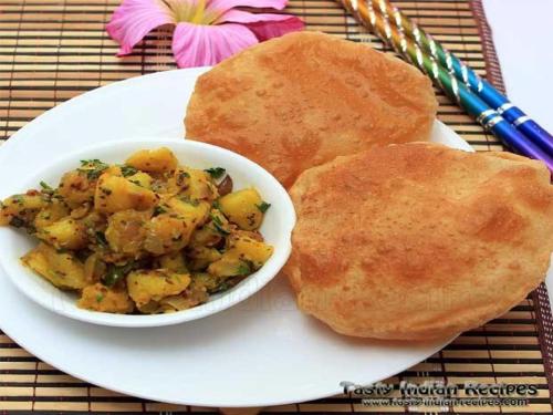 a plate of food with a bowl of potato salad and bread at Hotel MANUAL GRAND Near International Airport BY-Gross Group in New Delhi