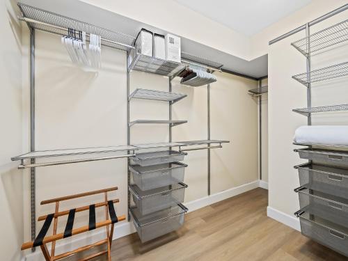 a walk in closet with metal shelving and a wooden chair at Walk to Las Olas Heated Splash Pool Jacuzzi in Fort Lauderdale