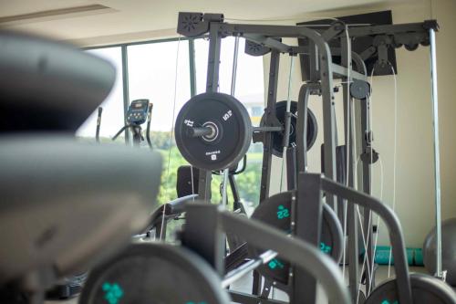 a gym with a bunch of weights at Park Apartments in Accra