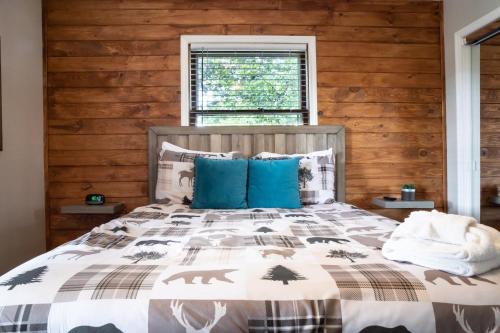 a bedroom with a large bed with blue pillows at Modern Mountain - Welcoming House in Tennessee in Sevierville