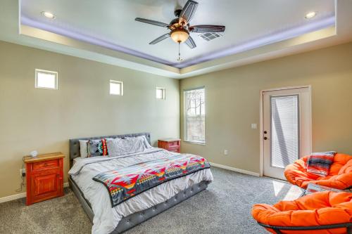 a bedroom with a bed and two chairs at Unique Las Cruces Home with Patio and Gas Grill! in Las Cruces