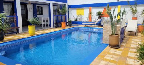 a swimming pool with blue water in a house at Riad Ghazal in Essaouira