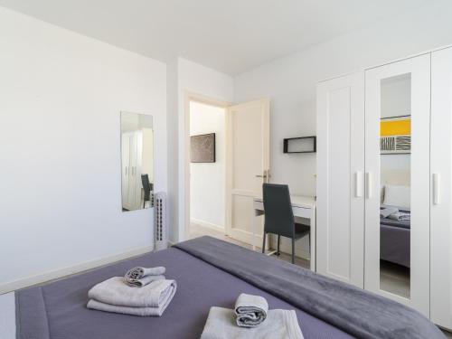 a bedroom with a bed with towels on it at Armonia Pool View & Wi-Fi by iRent Fuerteventura in Corralejo