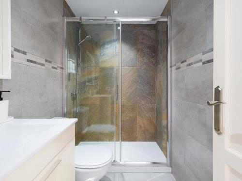 a bathroom with a shower and a toilet at Armonia Pool View & Wi-Fi by iRent Fuerteventura in Corralejo
