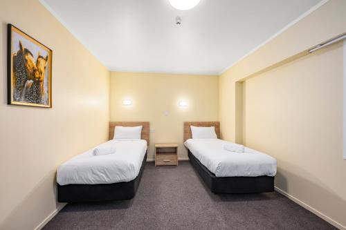 a room with two beds in a room at Fenton Court Motel in Rotorua