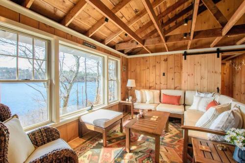 a living room with a couch and a table at 10 ft from Crystal Lake New renovation in Orleans