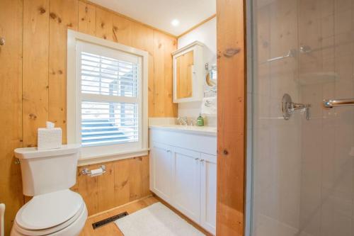 a bathroom with a toilet and a glass shower at 10 ft from Crystal Lake New renovation in Orleans
