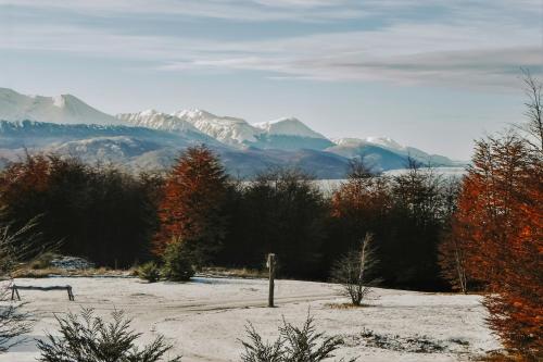 a snow covered field with mountains in the background at Wyndham Garden Ushuaia Hotel del Glaciar in Ushuaia