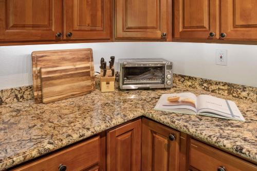 a kitchen counter with a book and a toaster oven at Faeya Grove in Forestville