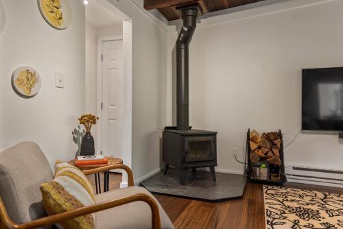 a living room with a wood stove in a room at Faeya Grove in Forestville