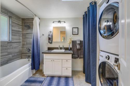 a bathroom with a sink and a washing machine at Faeya Grove in Forestville