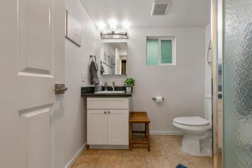 a bathroom with a white toilet and a sink at Faeya Grove in Forestville